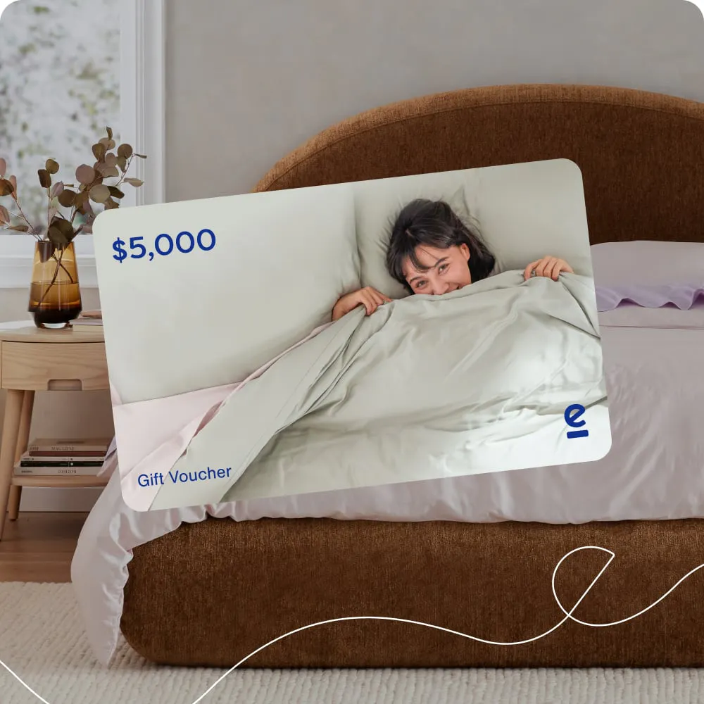 $5,000 Ecosa gift voucher in front of a made bed